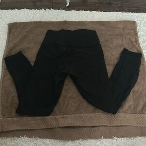 Black Lululemon leggings with mesh stripes on the back